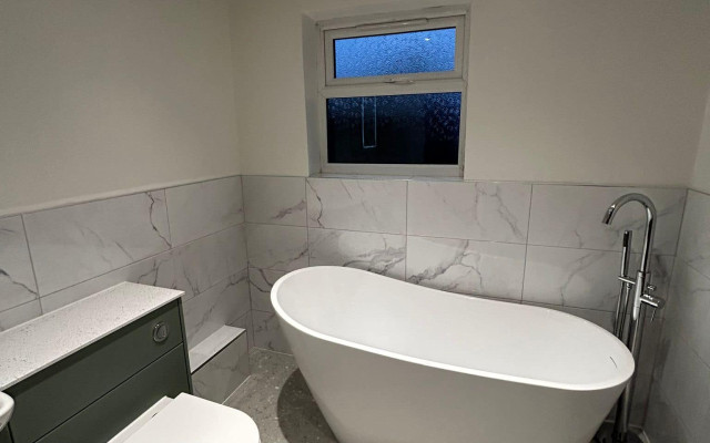 Beautiful modern bathroom featuring a sleek freestanding bath and elegant furnishings from Bristol Plumbing Supplies. Transform your space with our expert solutions!