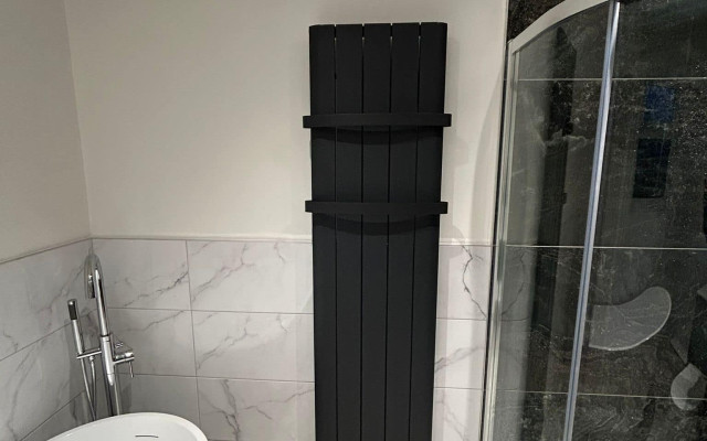 Bristol Plumbing Supplies bathroom project featuring a stylish black radiator.